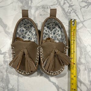 Baby moccasins. Tan/grey with blue and white flowers inside